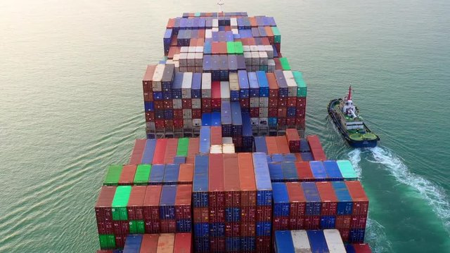 4k, Hyper lapse aerial view container ship loading and unloading in deep sea port, Aerial top view of logistic import export transportation business by container ship in open sea.