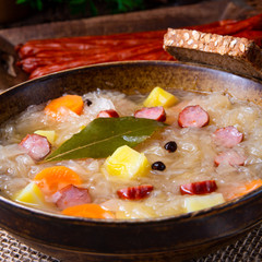 rustic sauerkraut soup with bacon and sausage
