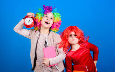 School alarm. Girl worry about time. Discipline and time concept. Circus school education. Time to have fun. Kids colorful curly wig clown style hold alarm clock. I am not joking about discipline