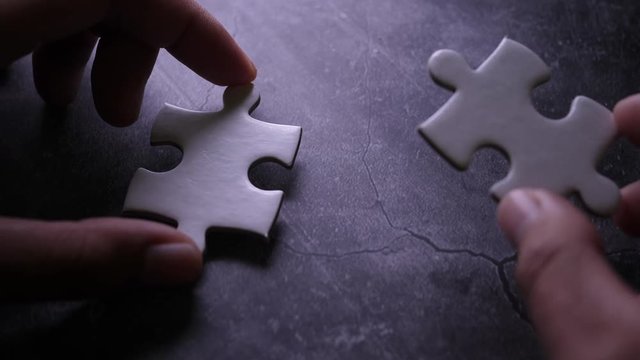 Piece of white jigsaw filling by hand, Success concept