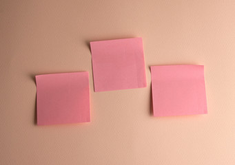 three pink paper stickers pasted on white background