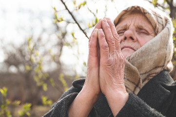 Grandmother pray for faith spirituality and religion. Asking God for good luck, success, forgiveness.Power of religion, worship, belief. Warm tone