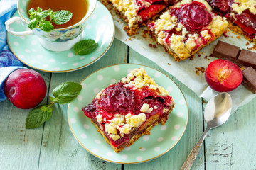 Sweet pie, tart with fresh plum. Delicious cake with plum on kitchen table.