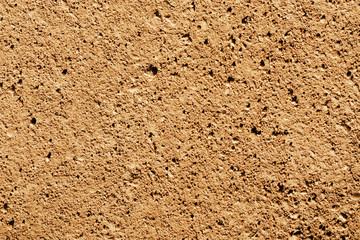Sandy yellow rocky road texture. Natural earth path backdrop.
