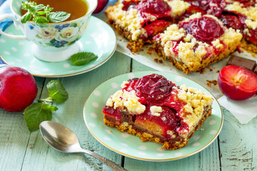 Sweet pie, tart with chocolate and fresh plum. Delicious cake with plum on kitchen table.