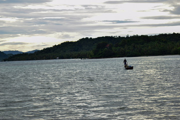 Defocused shot Fisherman boat at middle of the sea are catching fresh fish for supply to Kota...