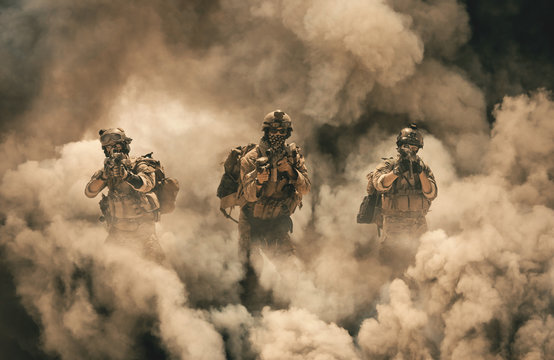 Military soldier between smoke and dust in battlefield