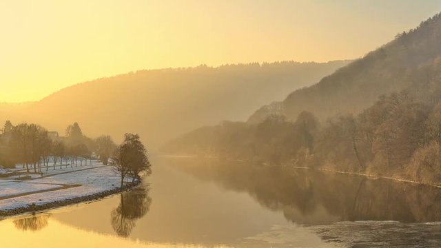 Sunset over a river landscape in a central mountain range in winter. River Neckar in Southern Germany - 2.5D parallax