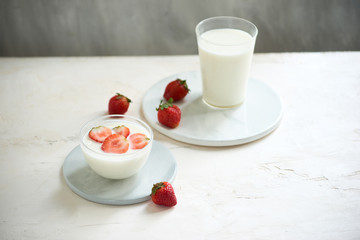 Fresh strawberry on a glass with dessert yogurt and strawberry  on white background