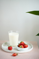 strawberry and yogurt on pink background