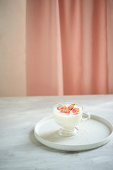 fresh organic yogurt with strawberries on table