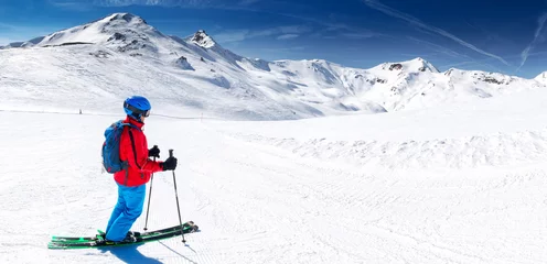 Fotobehang Skier posing in famous ski resort in Alps, Livigno, Italy, Europe. © Eva Bocek