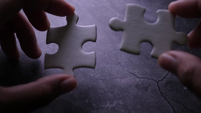 Piece of white jigsaw filling by hand, Success concept