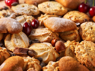 Oatmeal Cookies and sand chocolate cake with nut on wooden table in farm style close up. Perfect product.