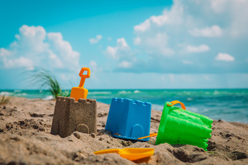 sand castle and toys on tropical beach vacation