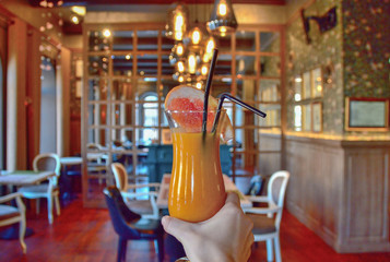 Fototapeta premium a tall glass cup with a of pumpkin grapefruit smoothie decorated