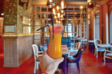 a tall glass cup with a of pumpkin grapefruit smoothie decorated