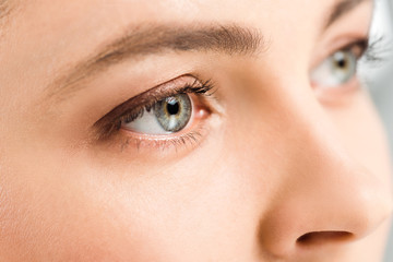 cropped view of woman with eye shadows on eyes looking away