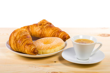 Delicious breakfast. Two croissants, a donut and a coffee on a wooden surface