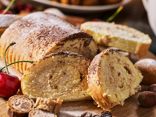 Cookies heart shape, sand rolled biscuit and cinnamon stick on wood table served dessert spoon at kitchen in rustic style. Morning sun flare. Problems with excess weight. Dark environment.
