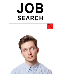 Young man with surprised eyes peeking out from behind billboard on inscription 