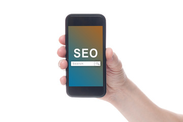 Hand holding black smartphone with text SEO (Search Engine Optimization) on smartphone screen. White backgroun. Seo concept