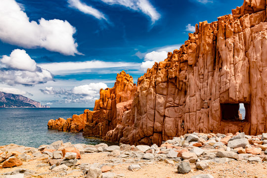 Sardinia, Italy, Rocks Arbatax - The red shining rock of porphyry, (Rocce Rosse) on the coast near Arbtax, is a popular tourist spot, on the east coast of Sardinia, a day in May.