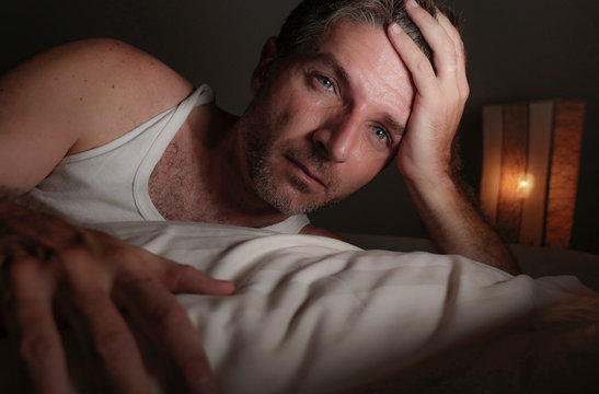 Close Up Face Portrait Of Sleepless And Awake Attractive Man With Eyes Wide Open At Night Lying On Bed Suffering Insomnia Sleeping Disorder Trying To Sleep