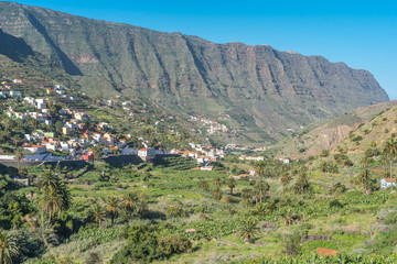 Fototapeta na wymiar The valley of Hermigua with several villages, high mountains and agricultural exploiting in the north-east of the island of La Gomera