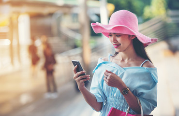 Beautiful woman with shopping bag Telephone on the overpass