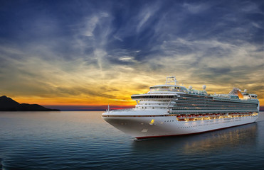 Fototapeta Luxury cruise ship sailing to port on sunset.  obraz