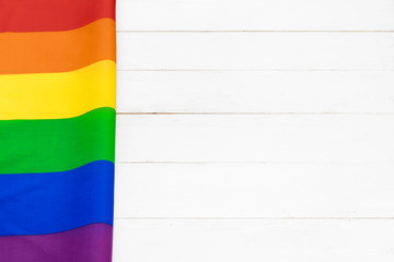 Gay pride flag on wooden table shot in studio