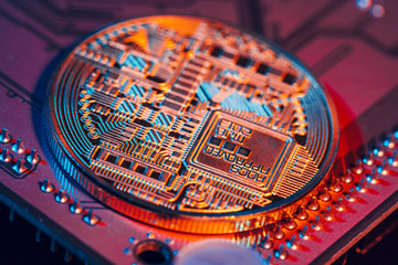 golden bitcoin and computer chip in background