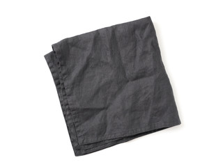 Folded dark black linen napkin isolated on white background. Anthracite grey linen napkin. Isolated...