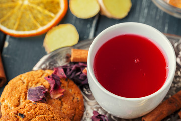 Cup of freshly brewed fruit and herbal tea, dark mood.Tea ceremony