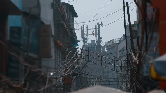 On the roof of the house in Delhi, India there are satellite dishes, mobile communication antennas, a radio relay dishes, blocks of the radio module of the base station equipment. Shot in motion