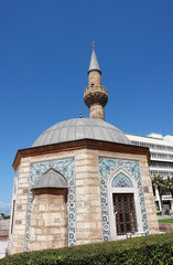 Fototapeta na wymiar Old small mosque (Konak Camii) on the central Konak square in Izmir, Turkey.