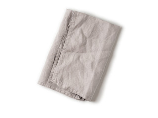 Folded gray linen napkin isolated on white background. Natural light gray linen napkin. Isolated on white with clipping path. Top view or flat lay.
