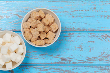 White refined sugar and brown unrefined sugar cubes