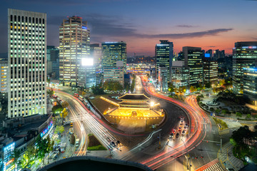 Namdaemun gate with Seoul business district at night in Seoul ,South Korea.