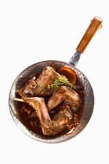 Portions of roasted wild rabbit with mushrooms