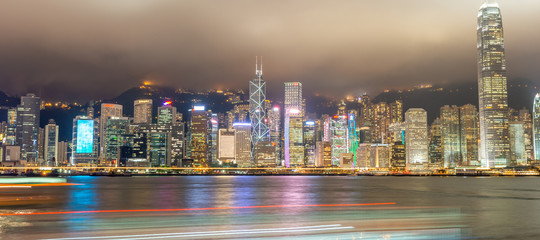 HONG KONG, CHINA - MAY 2014: City skyscrapers from Kowloon at night. Hong Kong attracts 15 million visitors every year