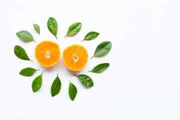 Fresh orange citrus fruit with green leaves on white.