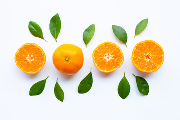 Fresh orange citrus fruit with green leaves on white.