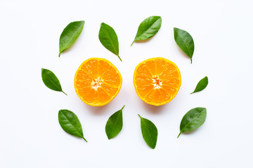 Fresh orange citrus fruit with green leaves on white.