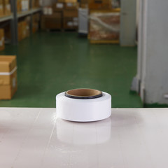 White thread spool in the warehouse of a textile factory. Thread for knitting production.