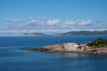 View of Capo Caccia from Alghero (L'Alguer), province of Sassari , Sardinia, Italy.  Famous for the beauty of its coast and beaches and its historical city center. 