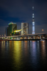 View of the Skytree Tower with the reflection in the river at night. Portrait orientation.
