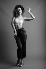 Fototapeta premium Young beautiful woman with curly hair posing in black and white