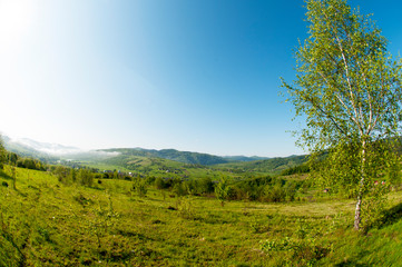 beautiful mountain valleys and mountains on a bright sunny day on the background of a wide valley